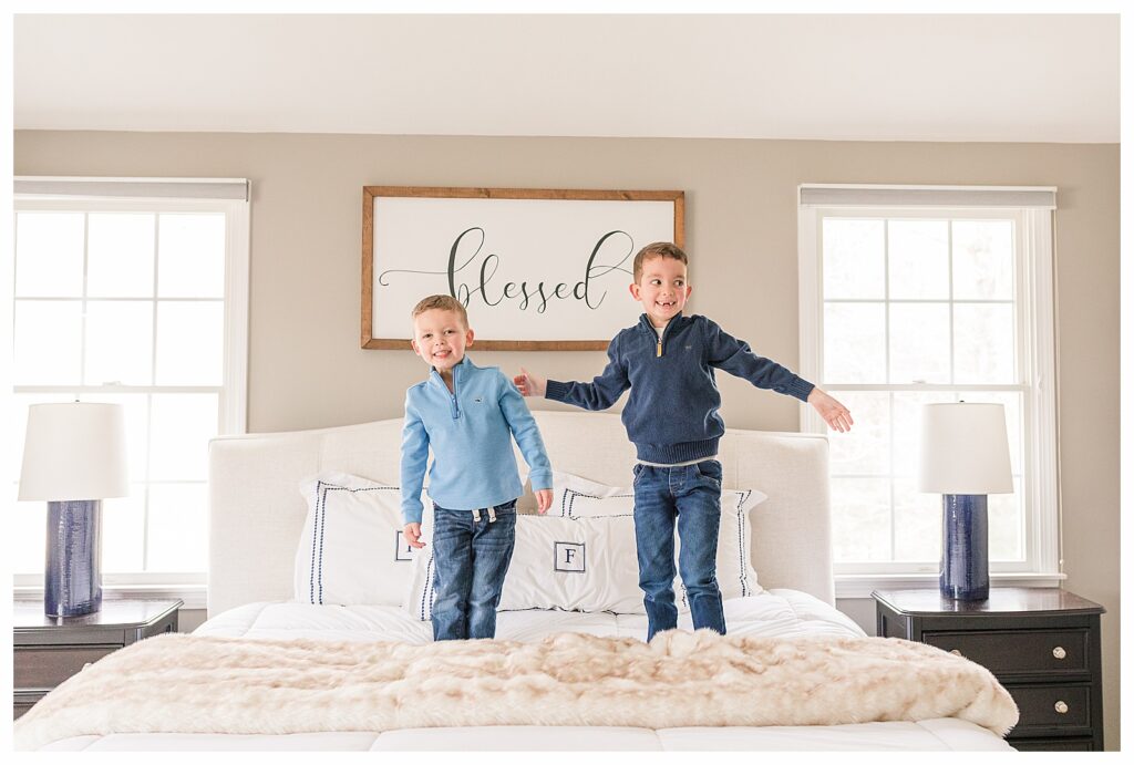 boys jump on bed for photos for NICU blog