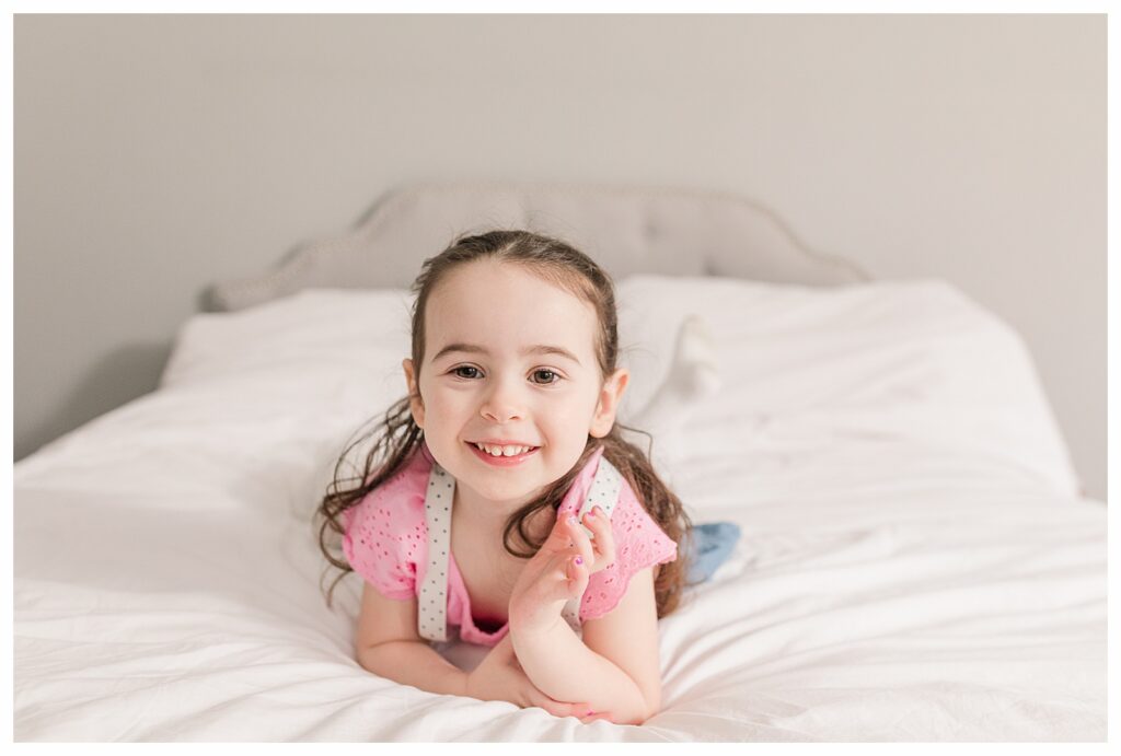 toddler smiling on bed Natick Family photographer