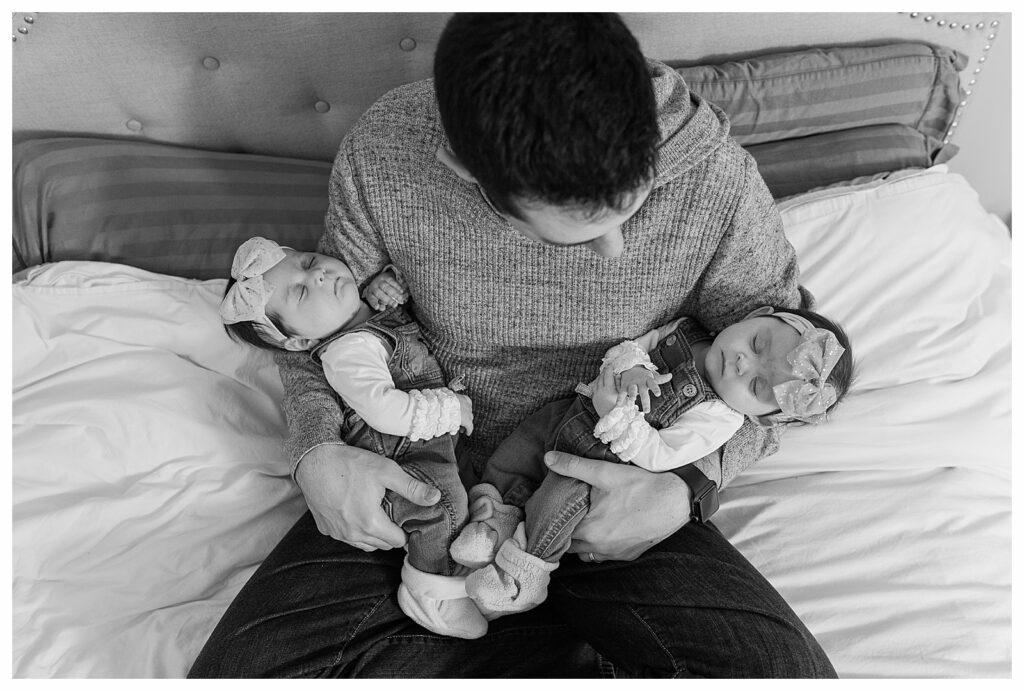 Norhthboro MA man holding twin Newborns photo