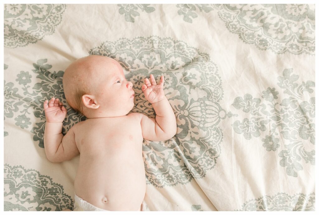 baby laying on bed newborn photo