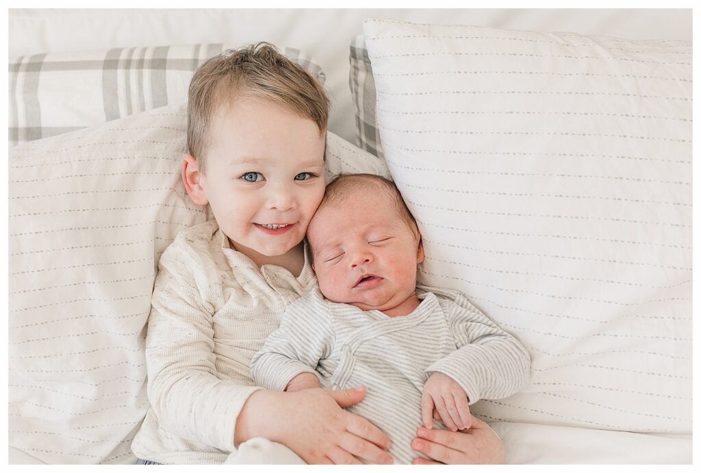 sibling photo on bed Natick newborn photo session
