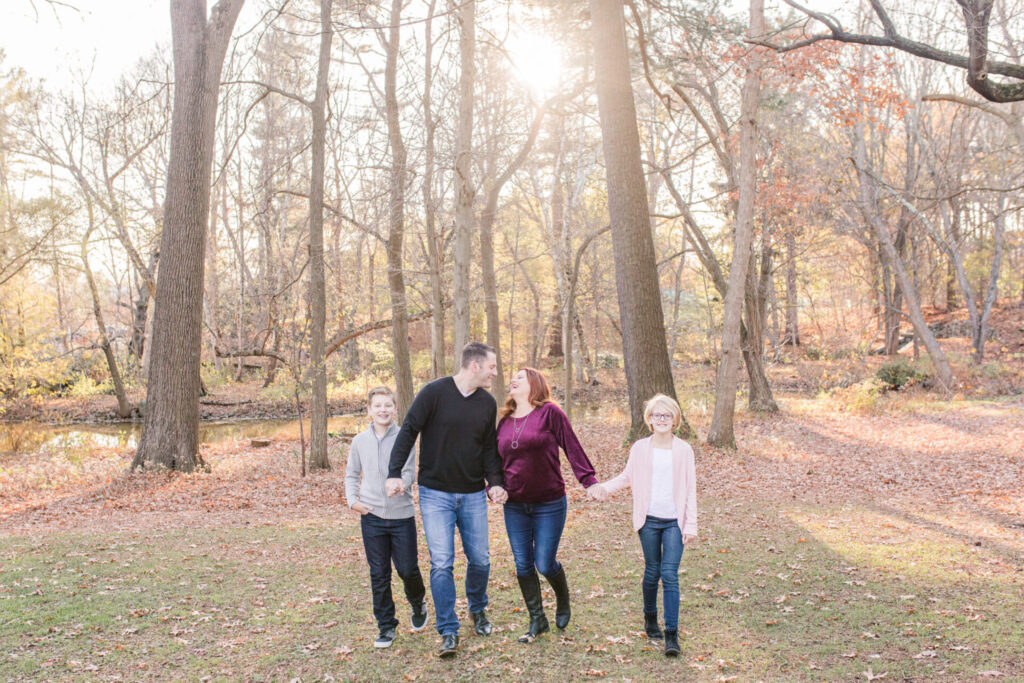 family walks and laughs together at photo session Wellesley MA