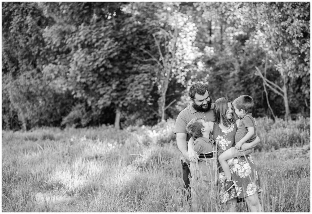 family hugs in field for lifestyle photo Needham MA/
