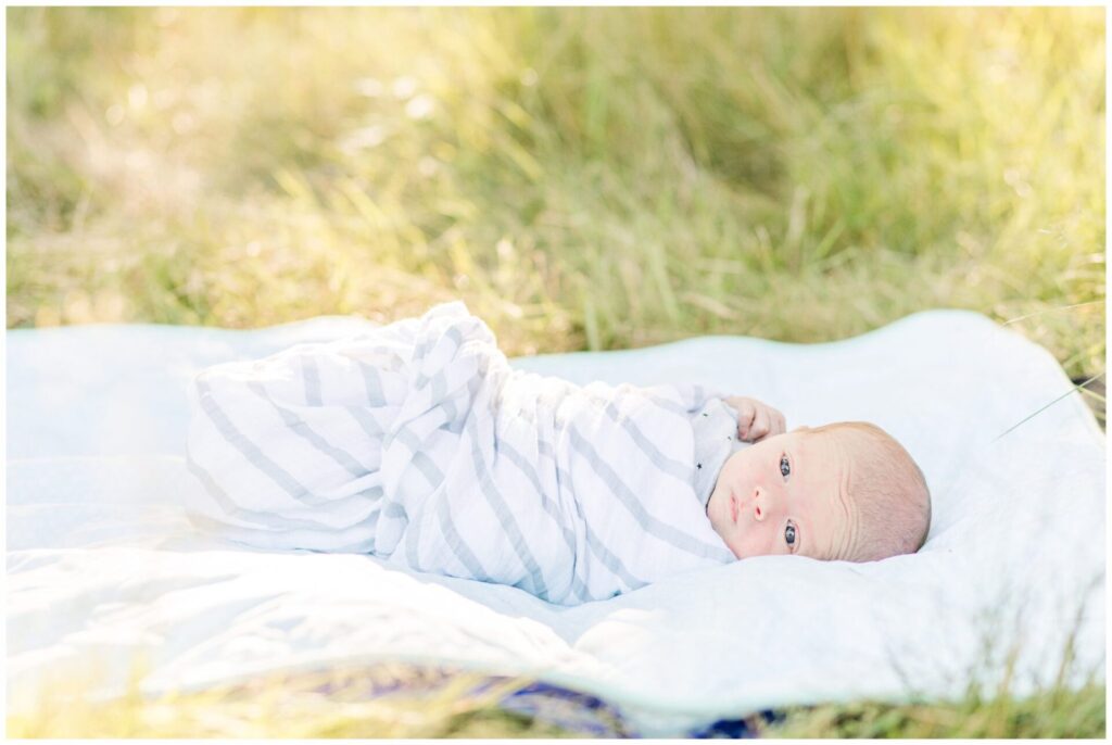 baby layes on blanket in Massachusetts for outside newborn photos