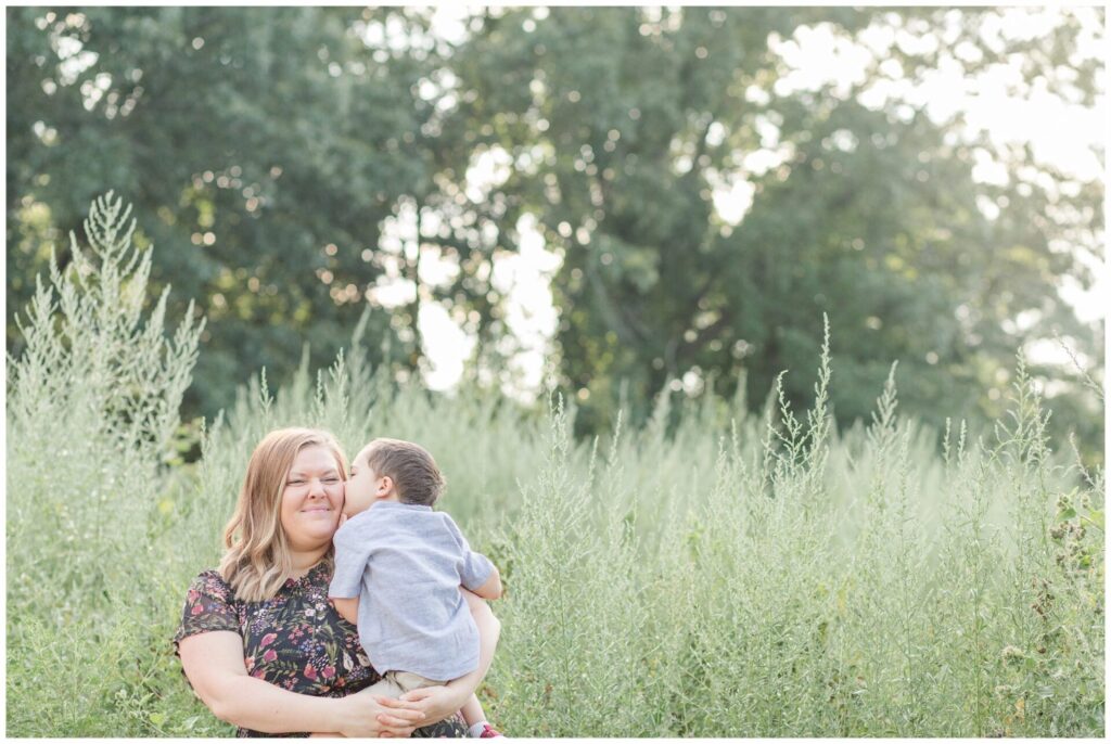 toddler boy kisses mom during family photo session Wellesley Massachusetts