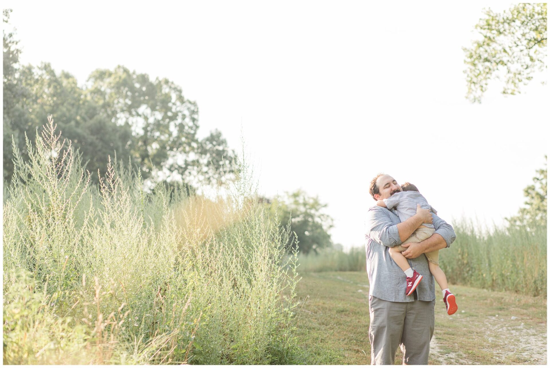 father hugs son for photo at Centennial Reservation Wellesley Massachusetts