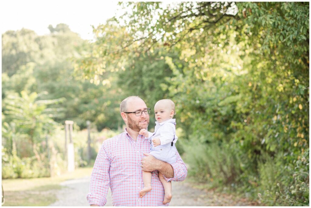 Dad walks holding son for family photo session in Newton Massachusetts