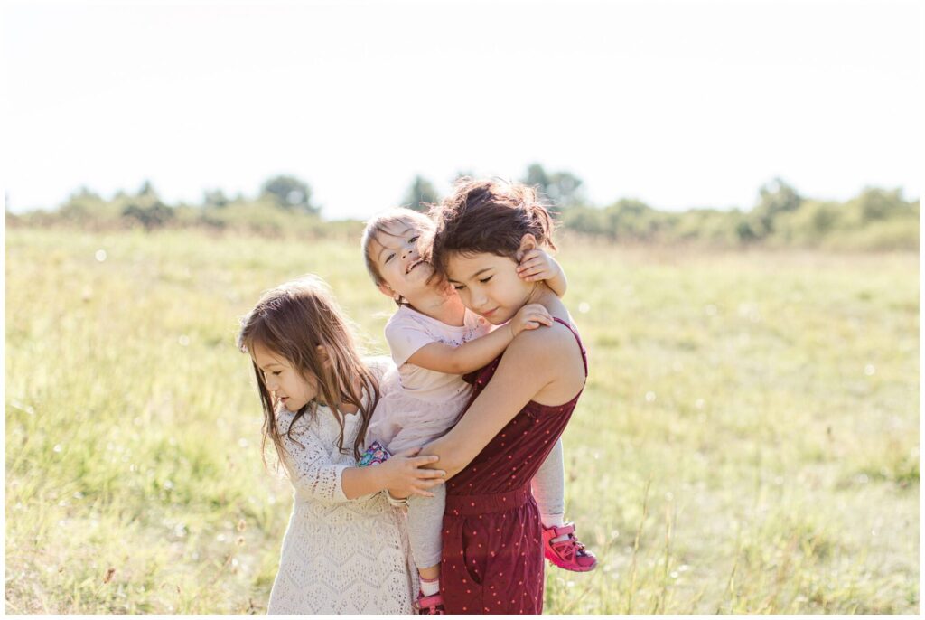 sisters hug each-other photo in field in Dover Massachusetts