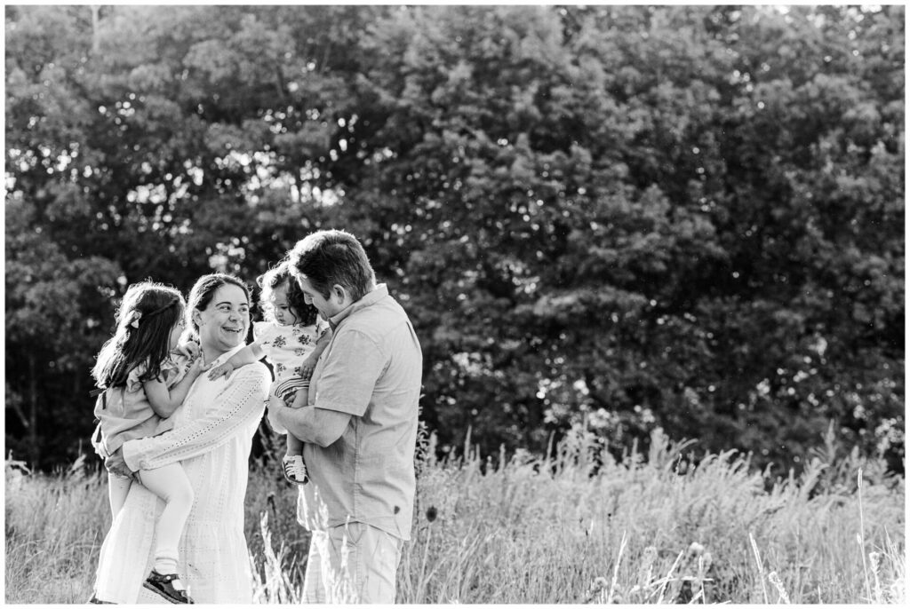 black and white MetroWest family photo session image family smiling together in field. 