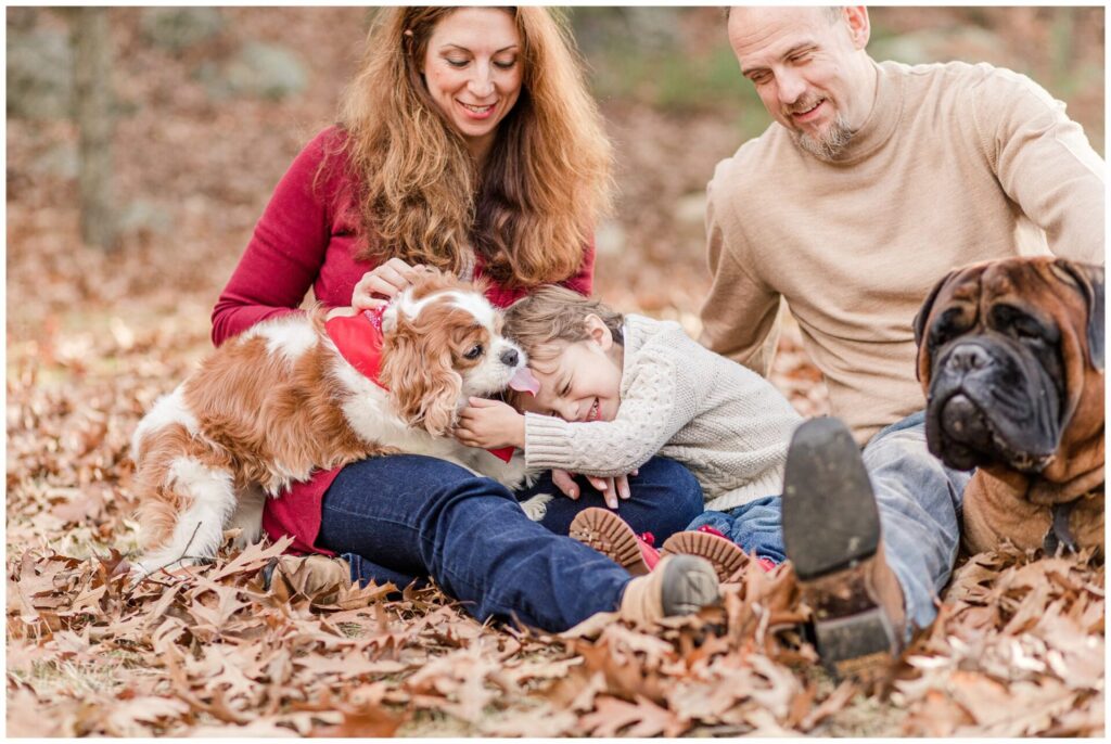 Family photo of dog kissing boy by Photographer in Natick MA