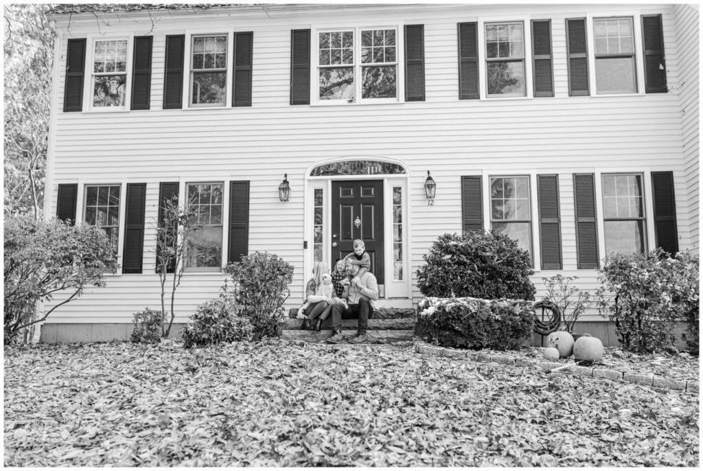 Black and white photo of Natick Massachusetts family in front of their home. 