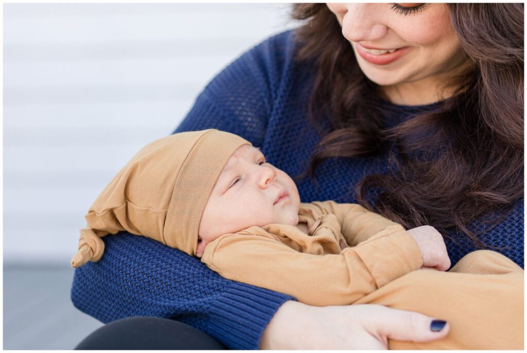 Mom smiling holding newborn baby, Photographer in Natick Massachusetts