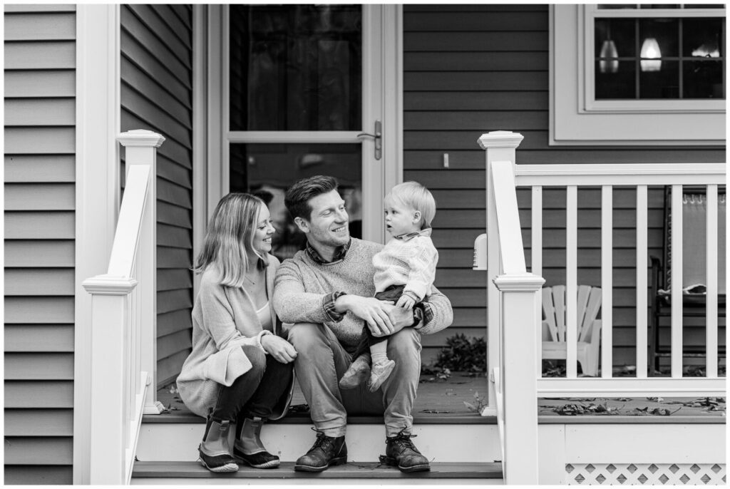 black and white photo of family sitting on porch of new house in Medway Massachusetts
