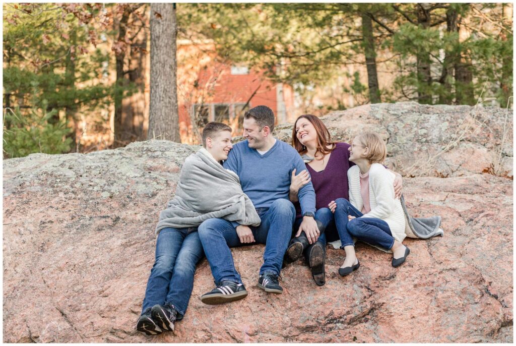 Family sitting on boulder Natick Massachusetts