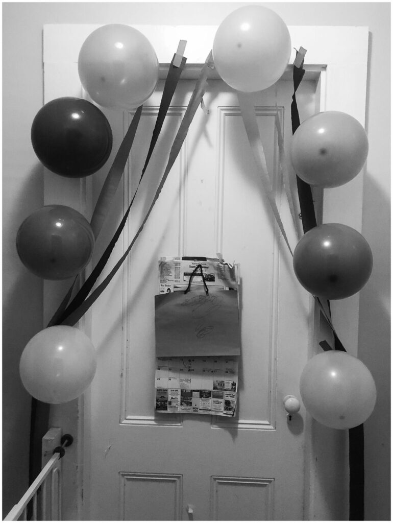 black and white photo of room decorated for birthday