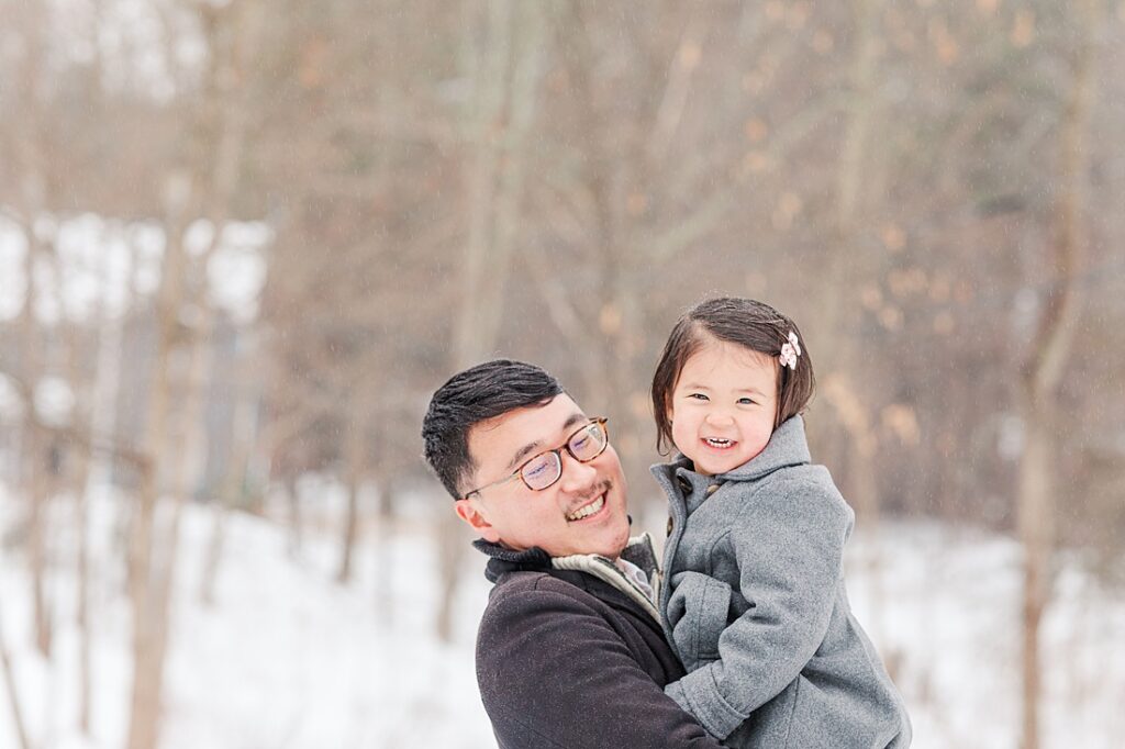 Father and daughter smile together for family photographer for NICU blog