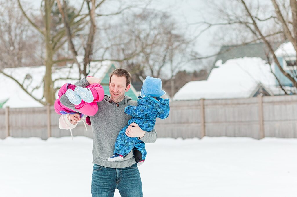 Dad holds son and daughter in the snow during photo session for NICU blog in Natick Massachusetts
