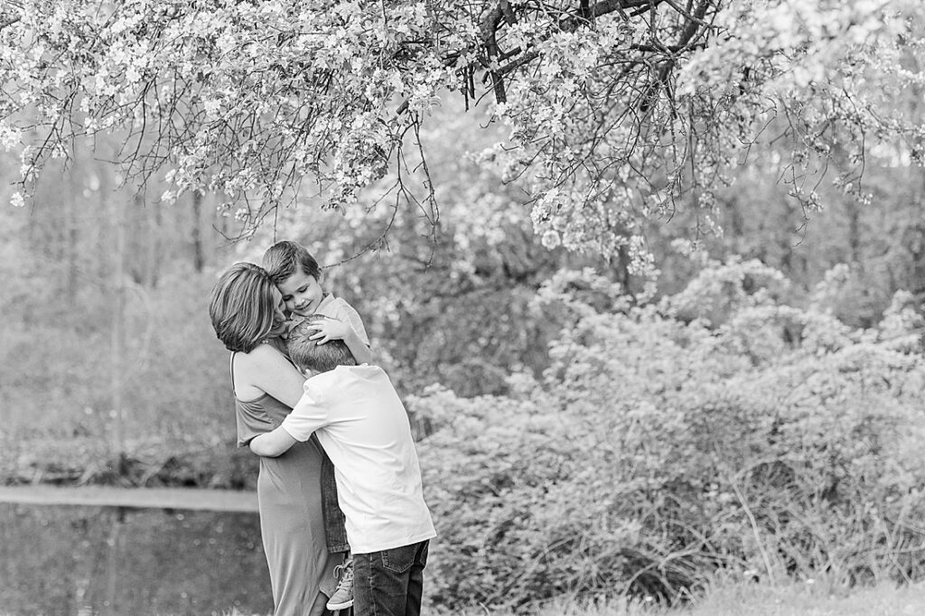 Mom hugs sons during family photo session with Sara Sniderman Photography at Heard Farm, Wayland Massachusetts
