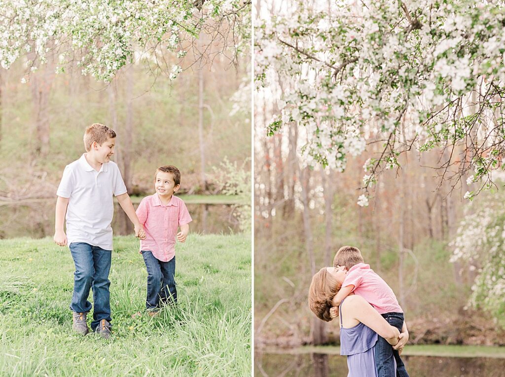 family smiles together among blooming apple trees during evening photo session with Sara Sniderman Photography at Heard Farm, Wayland Massachusetts