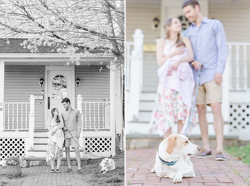 black and white of family standing in front of house and dog in focus with family out of focus behind during back yard newborn photo session with Sara Sniderman Photography in Natick Massachusetts. 