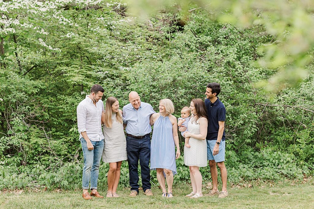 Family smiles at each other during family photo session with Sara Sniderman Photography at Elm Bank, Wellesley Massachusetts