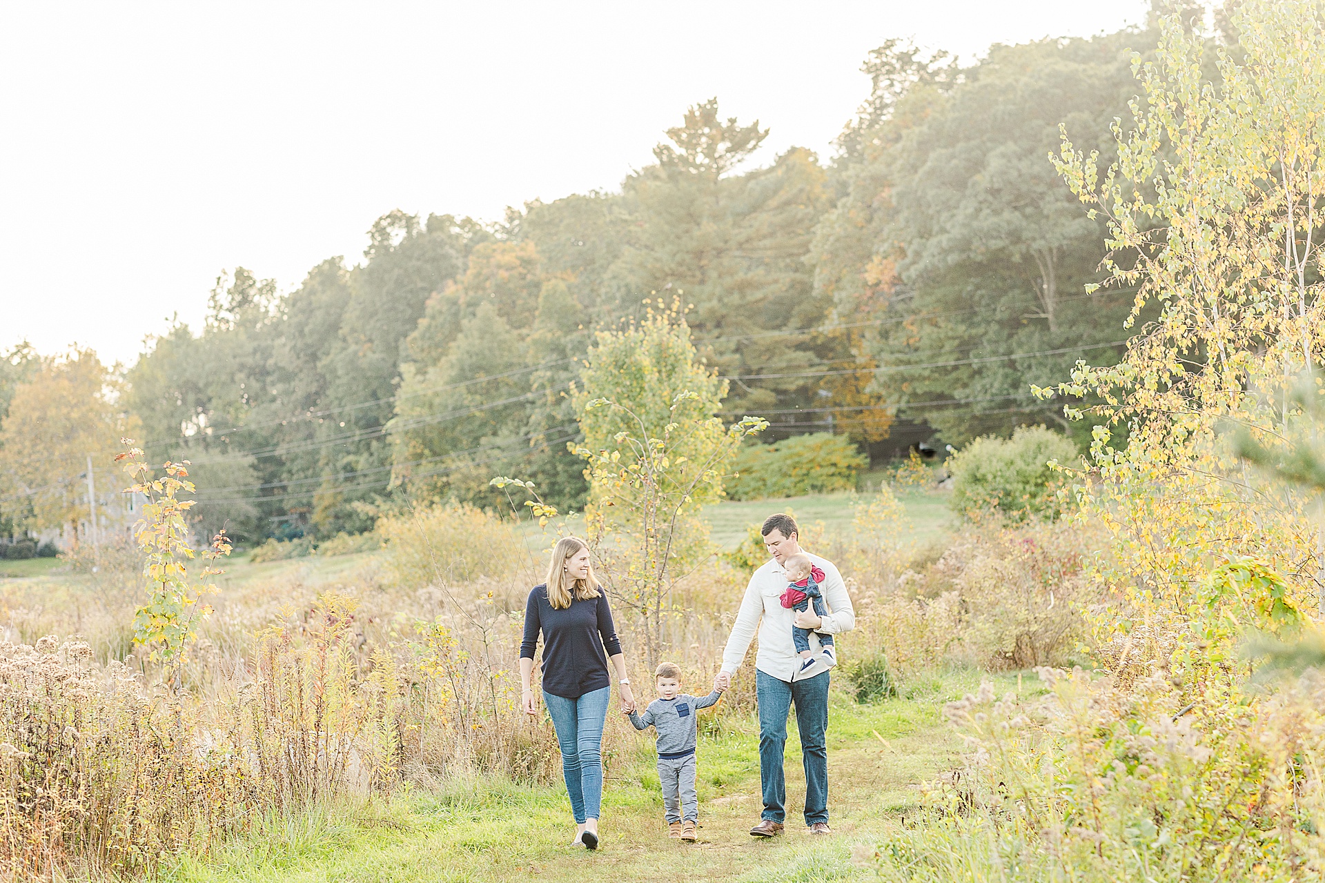family walks together during family photo session with Sara Sniderman Photography at Breakneck HIll Reservation, Southboro Massachusetts