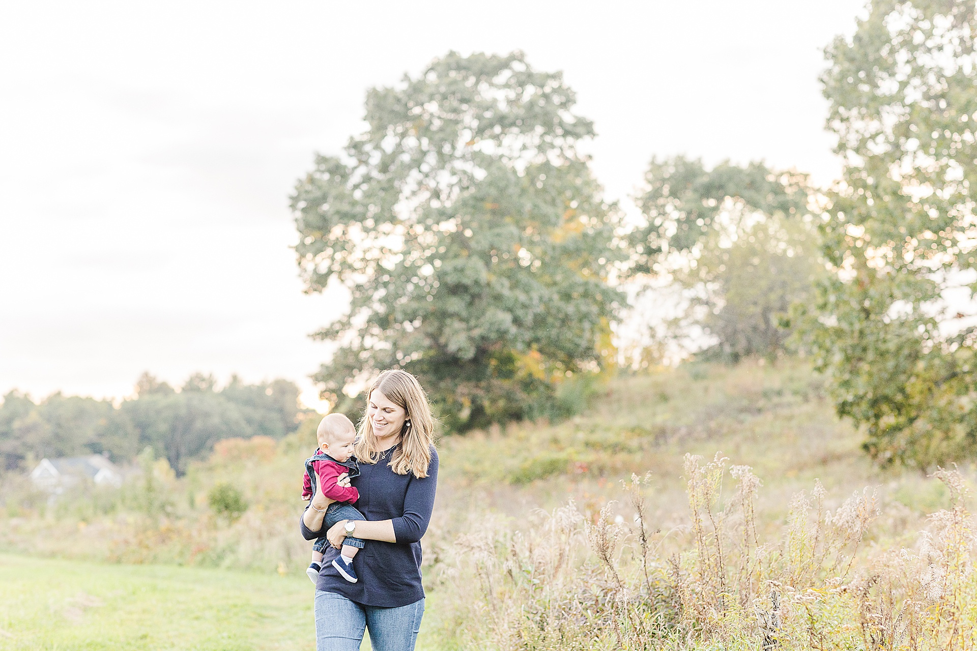 Mom holds baby during family photo session with Sara Sniderman Photography at Breakneck HIll Reservation, Southboro Massachusetts