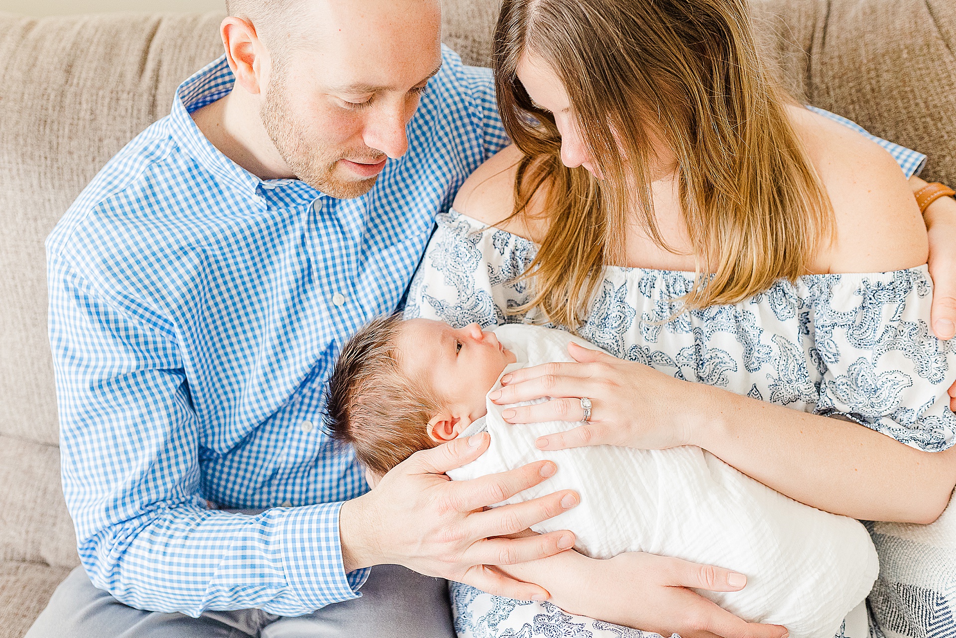 parents hold baby during in home newborn photo session with Sara Sniderman Photography 