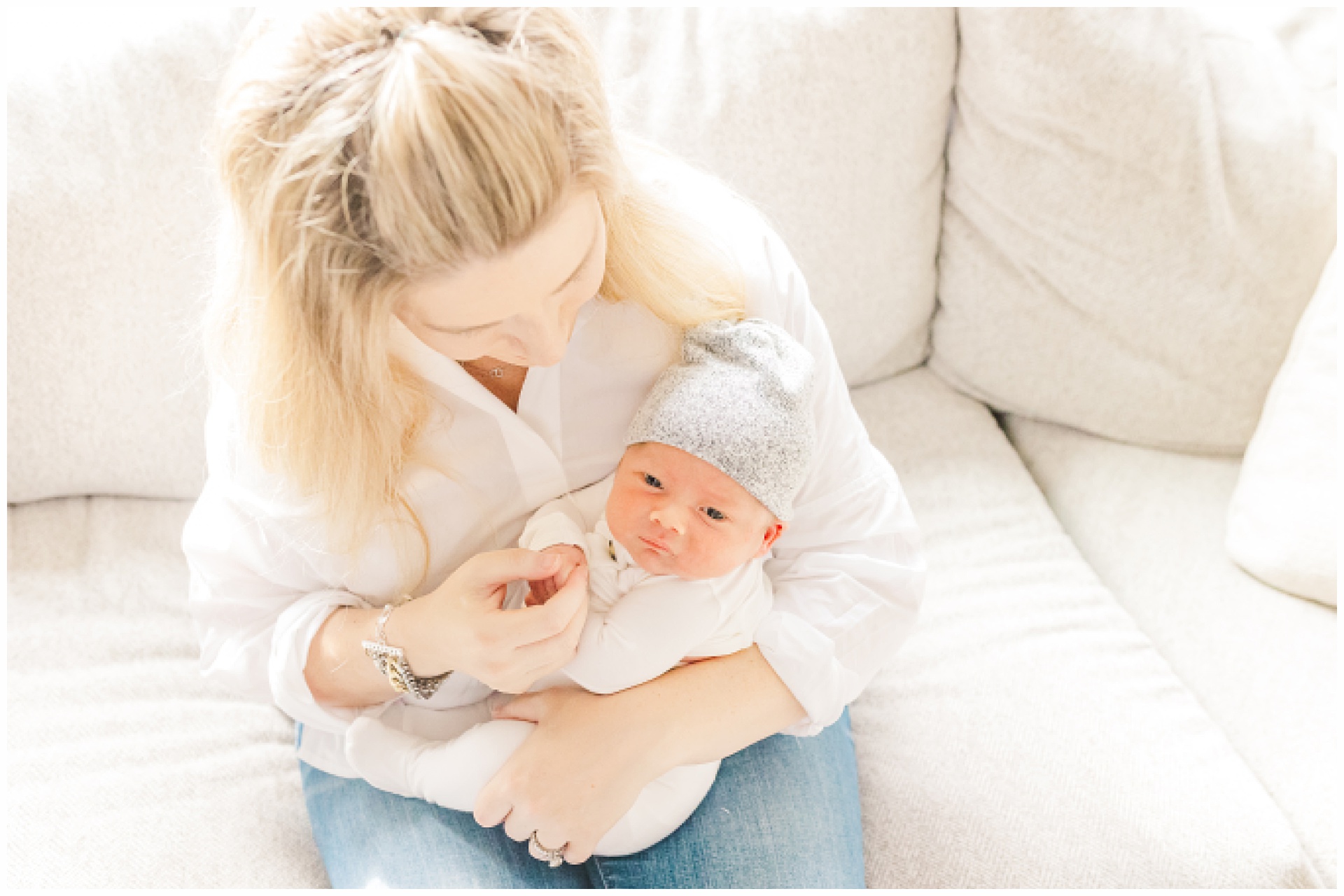 Mom holds baby during in home newborn photo session with Sara Sniderman Photography in Sherborn Massachusetts
