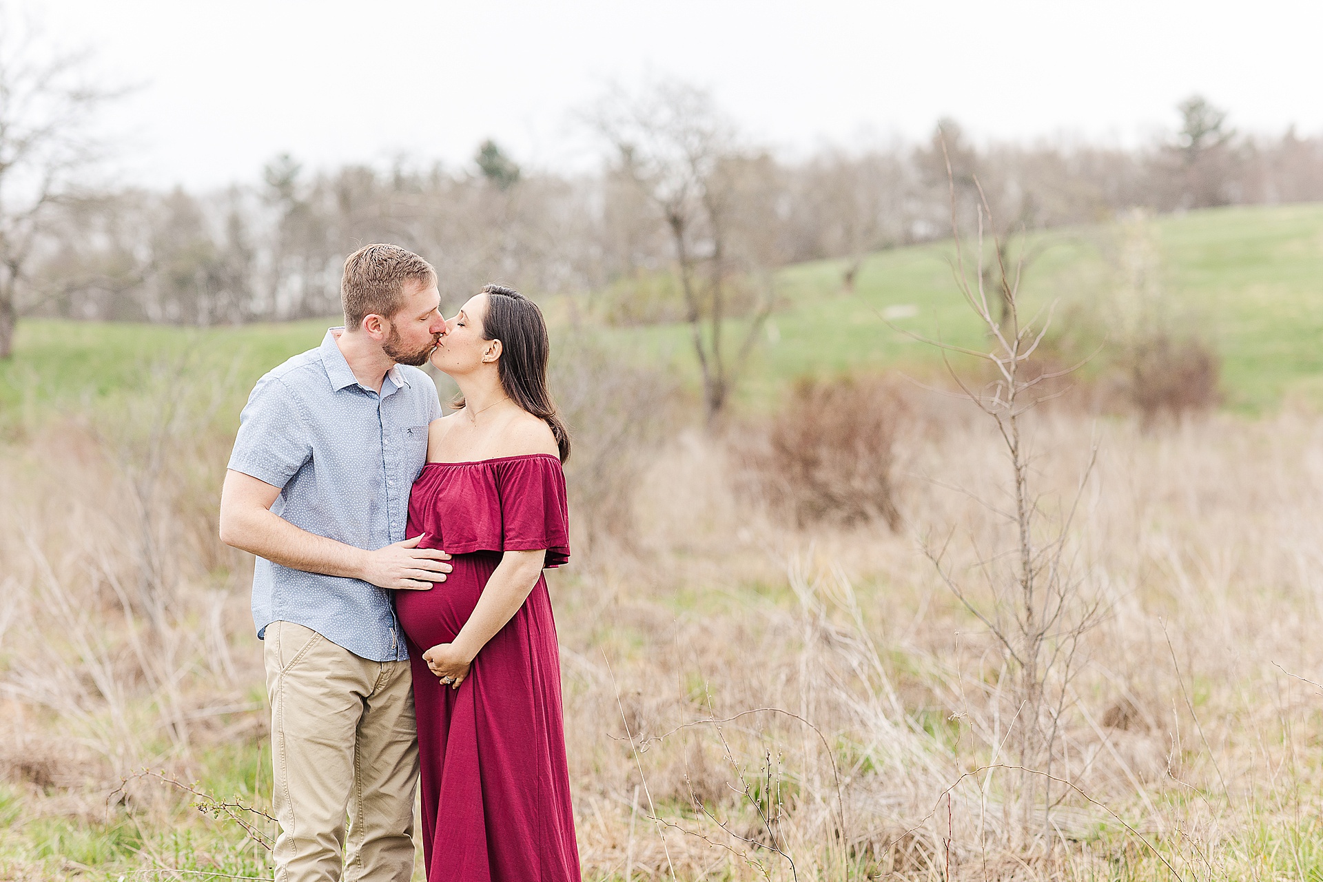 man and woman kiss during maternity photo session with Sara Sniderman Photography at Break Neck Hill southborough Massachusetts