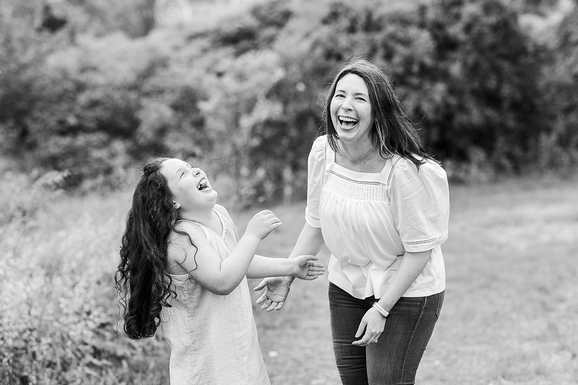 black and white of mother and daughter laughing during family photo session with Sara Sniderman Photography at Breakneck Hill Conservation Land, Southborough Massachusetts