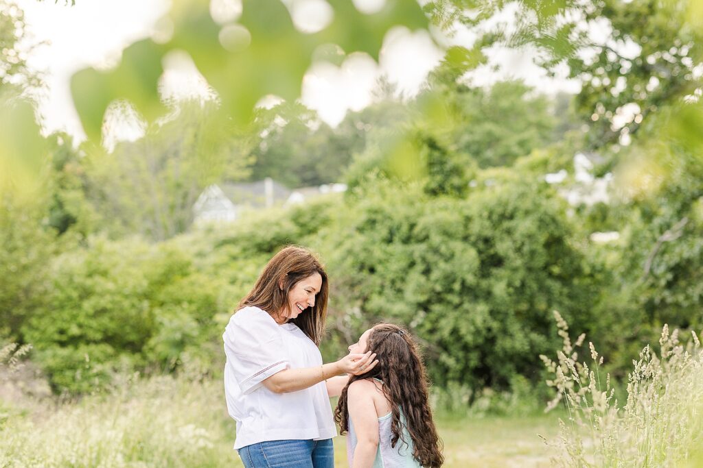 mother and daughter look at eachother during family photo session with Sara Sniderman Photography at Breakneck Hill Conservation Land, Southborough Massachusetts