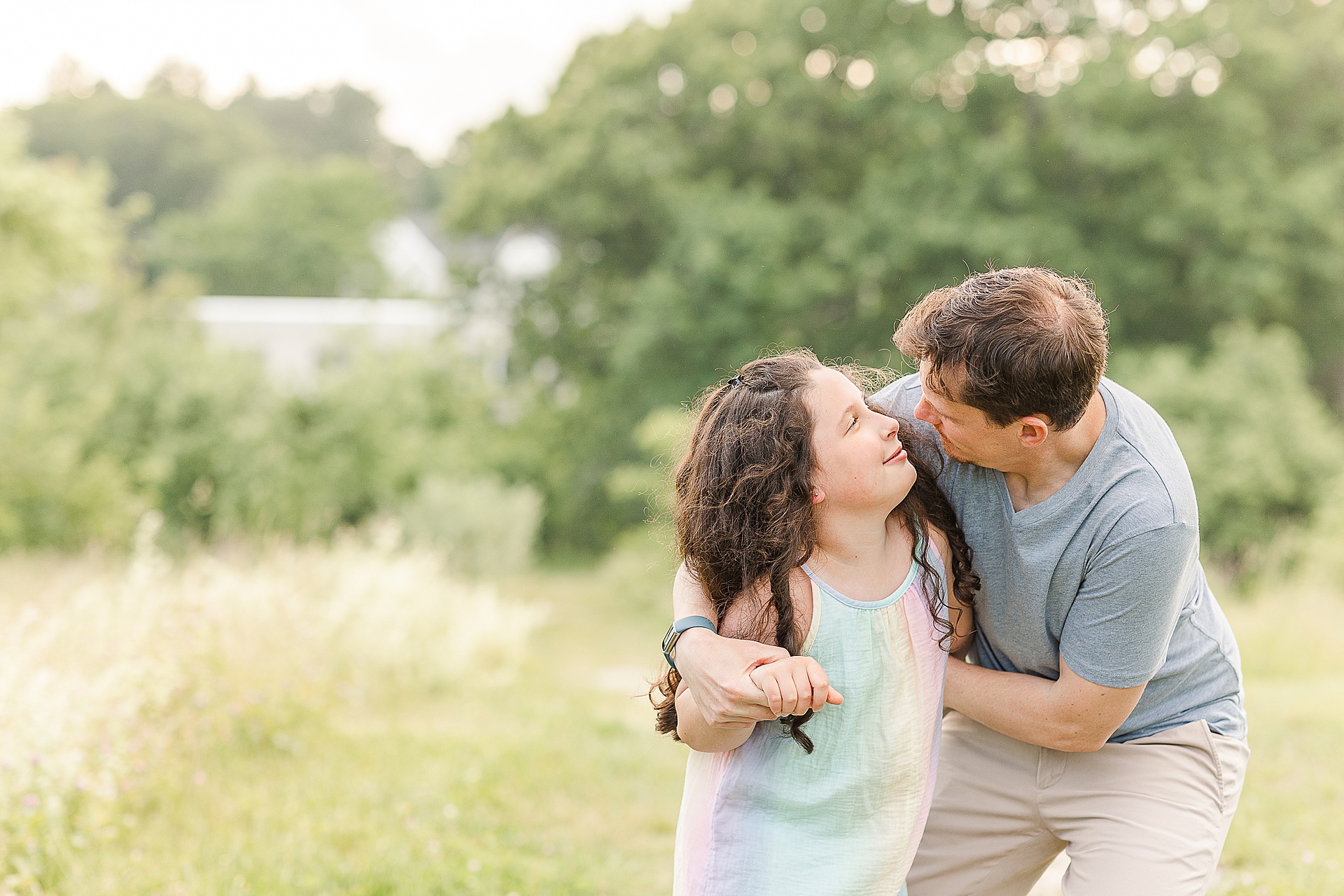 daughter and father look at each other during family photo session with Sara Sniderman Photography at Breakneck Hill Conservation Land, Southborough Massachusetts