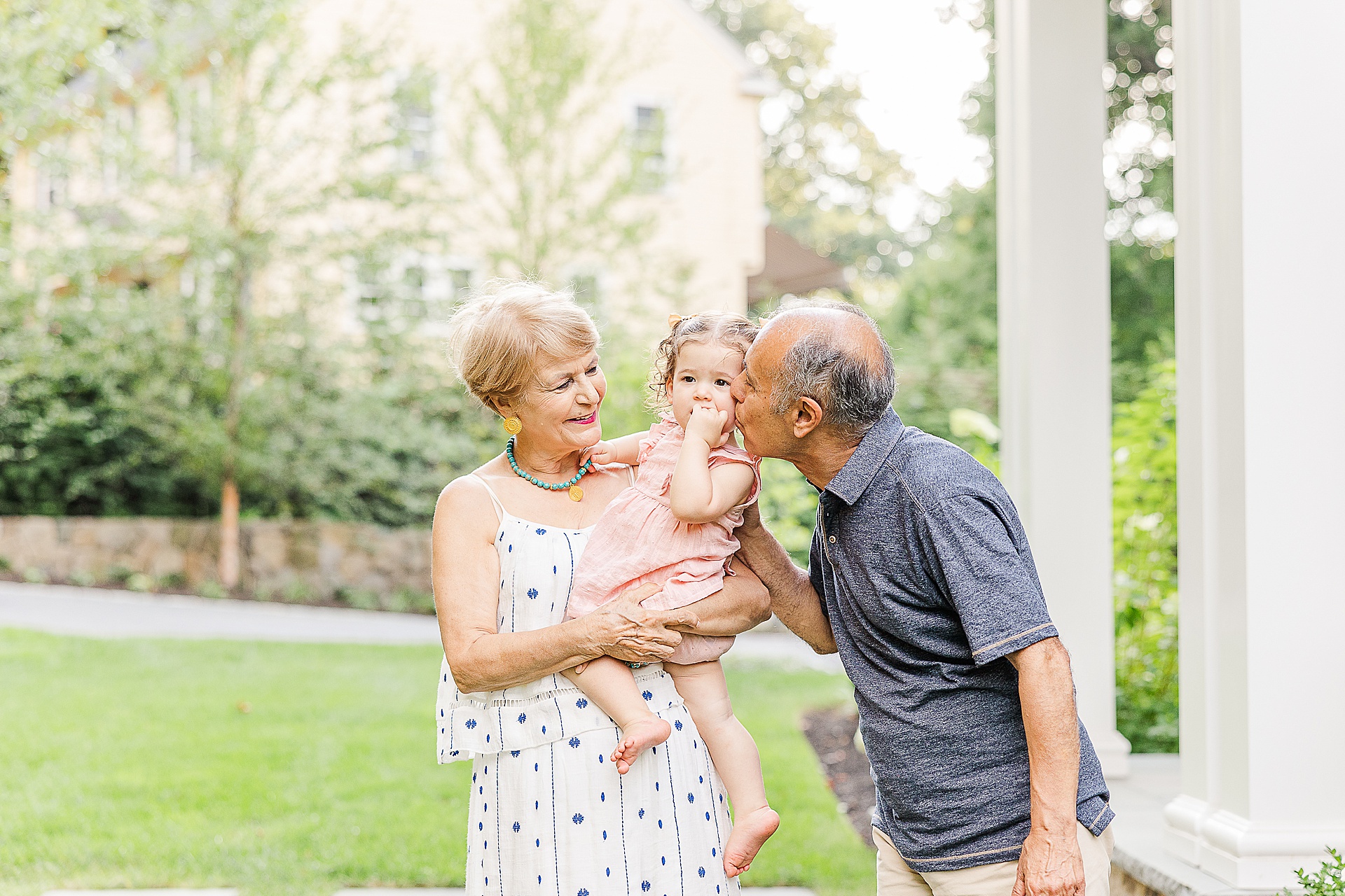 grandparents snuggle granddaughter during family photo session with Sara Sniderman Photography in Newton Massachusetts