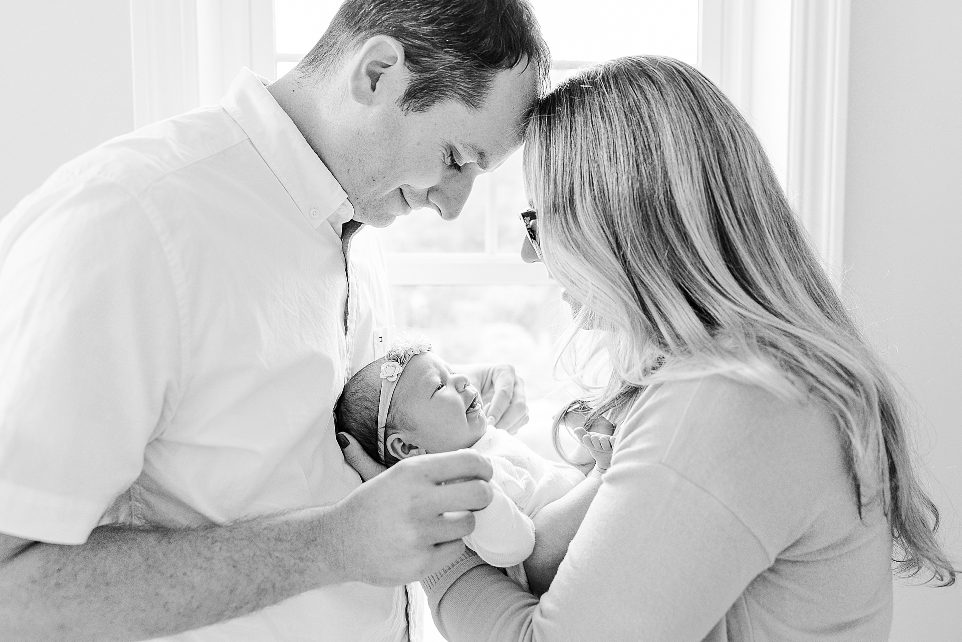 black and white photo of parents holding newborn during in home newborn photo session with Sara Sniderman Photography in Natick Massachusetts