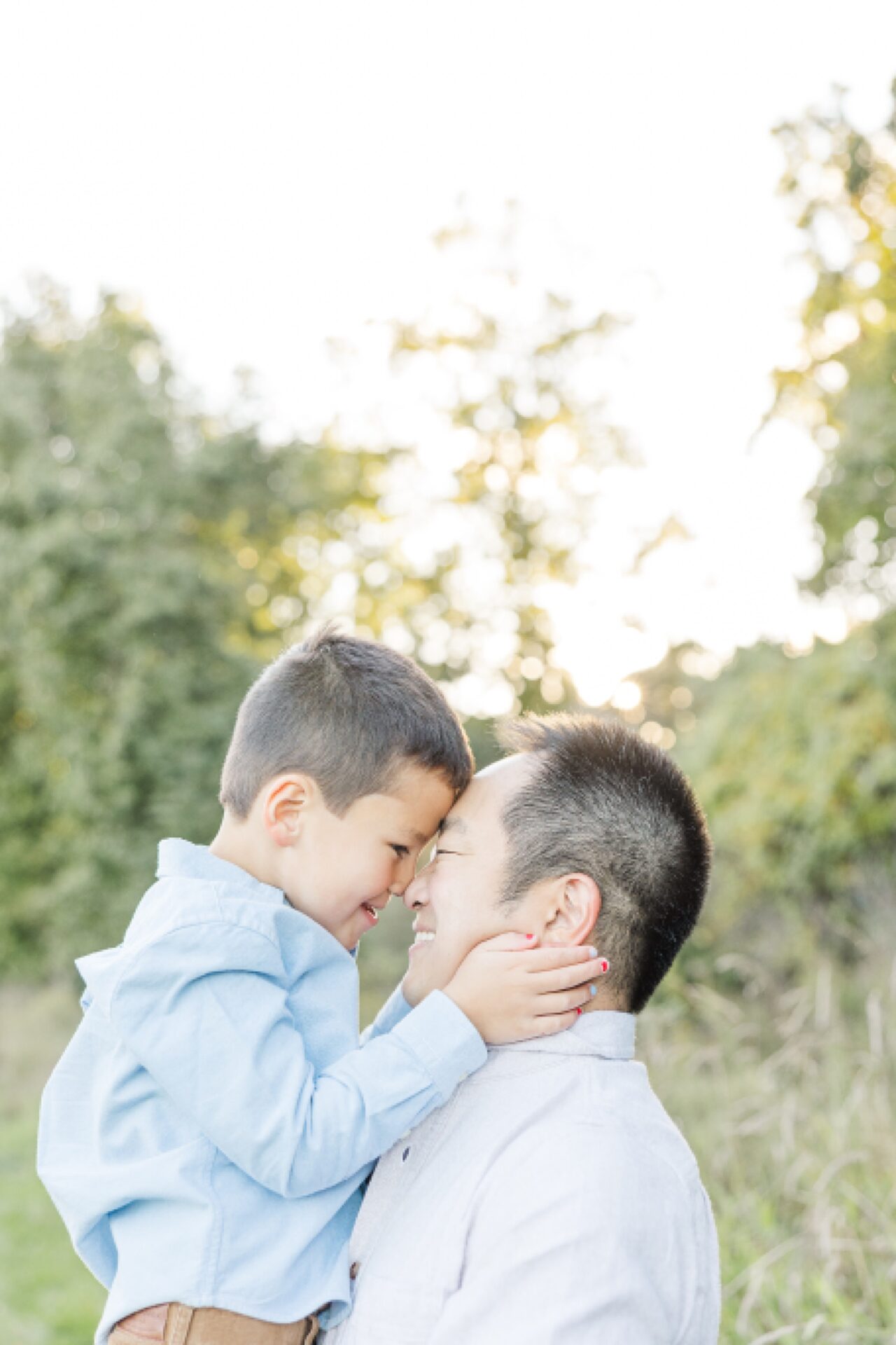 son and father rub noses during family photo session of the momming worker in Needham Massachusetts with Sara Sniderman Photography