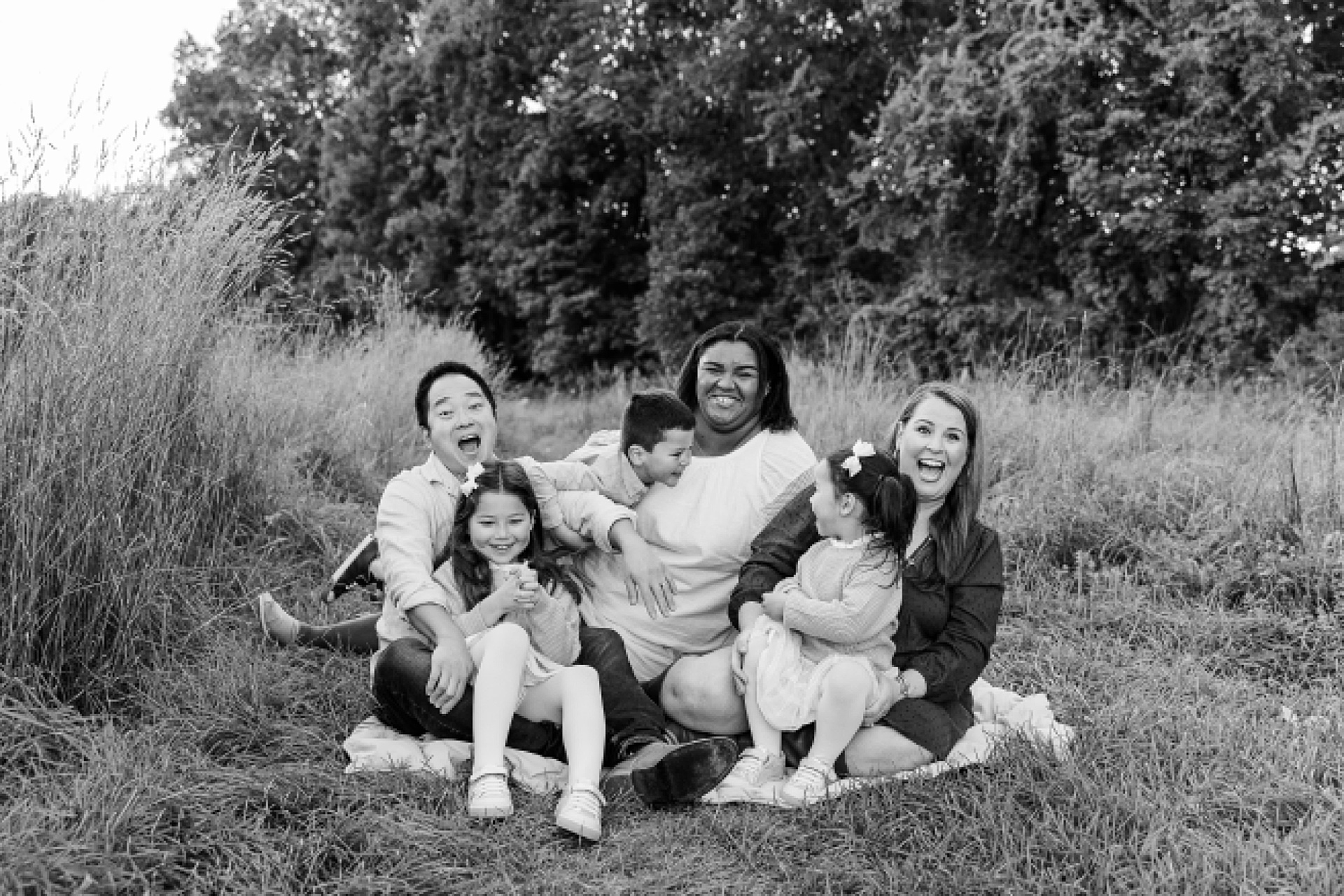 black and white of family laughing during family photo session of the momming worker in Needham Massachusetts with Sara Sniderman Photography