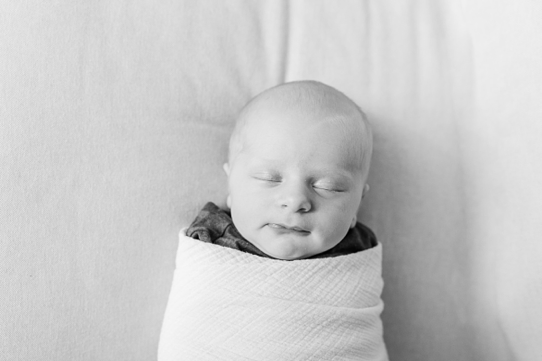 black and white photo of baby during Lifestyle newborn photo session in Needham Massachusetts with Sara Sniderman Photography