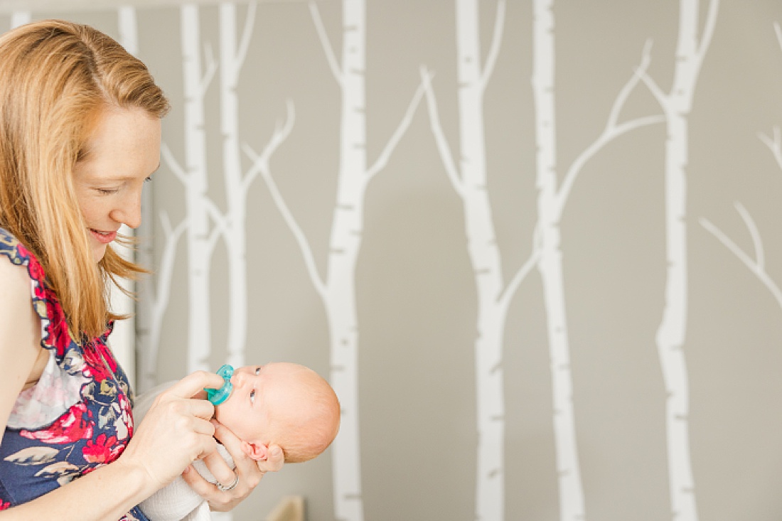 mom holds baby during Lifestyle newborn photo session in Needham Massachusetts with Sara Sniderman Photography