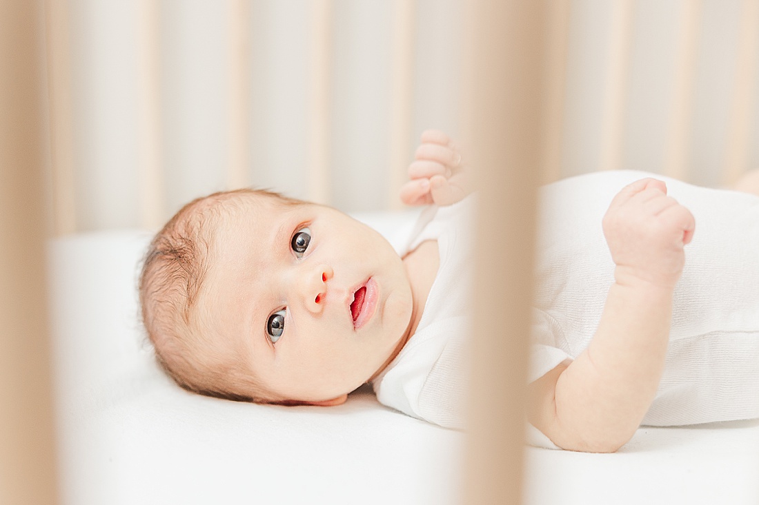 baby in crib during in-home newborn photo session in Natick Massachusetts with Sara Sniderman Photography