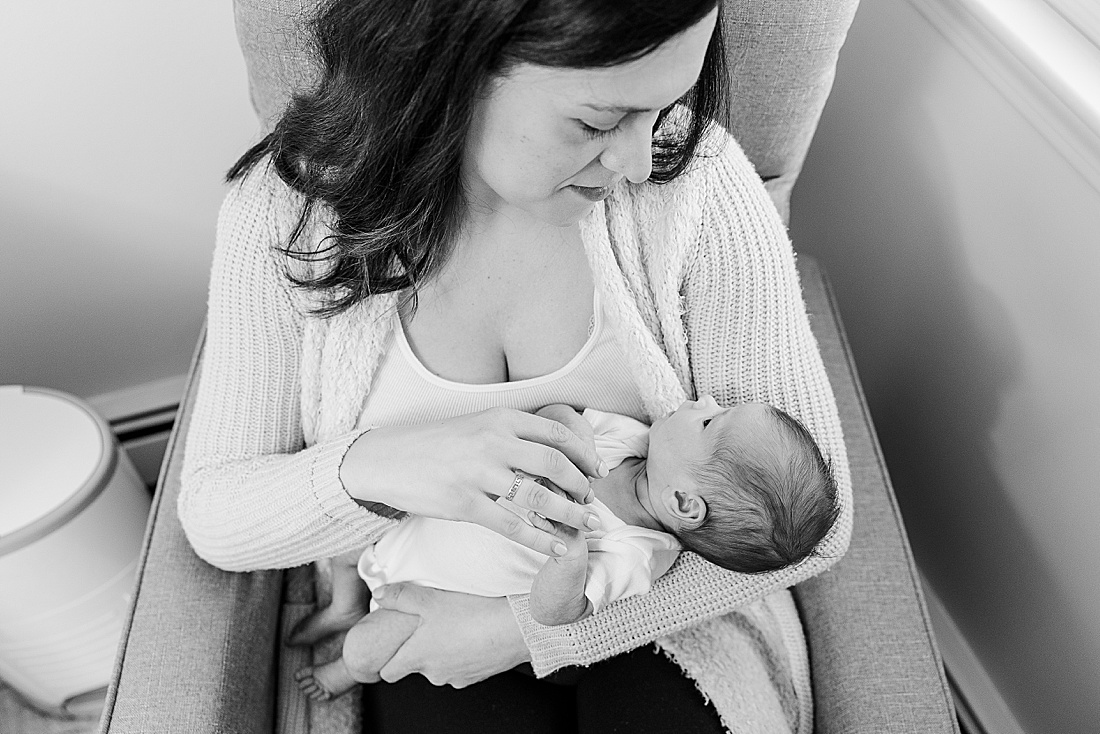 black and white of mom holding newborn during in-home newborn photo session in Natick Massachusetts with Sara Sniderman Photography