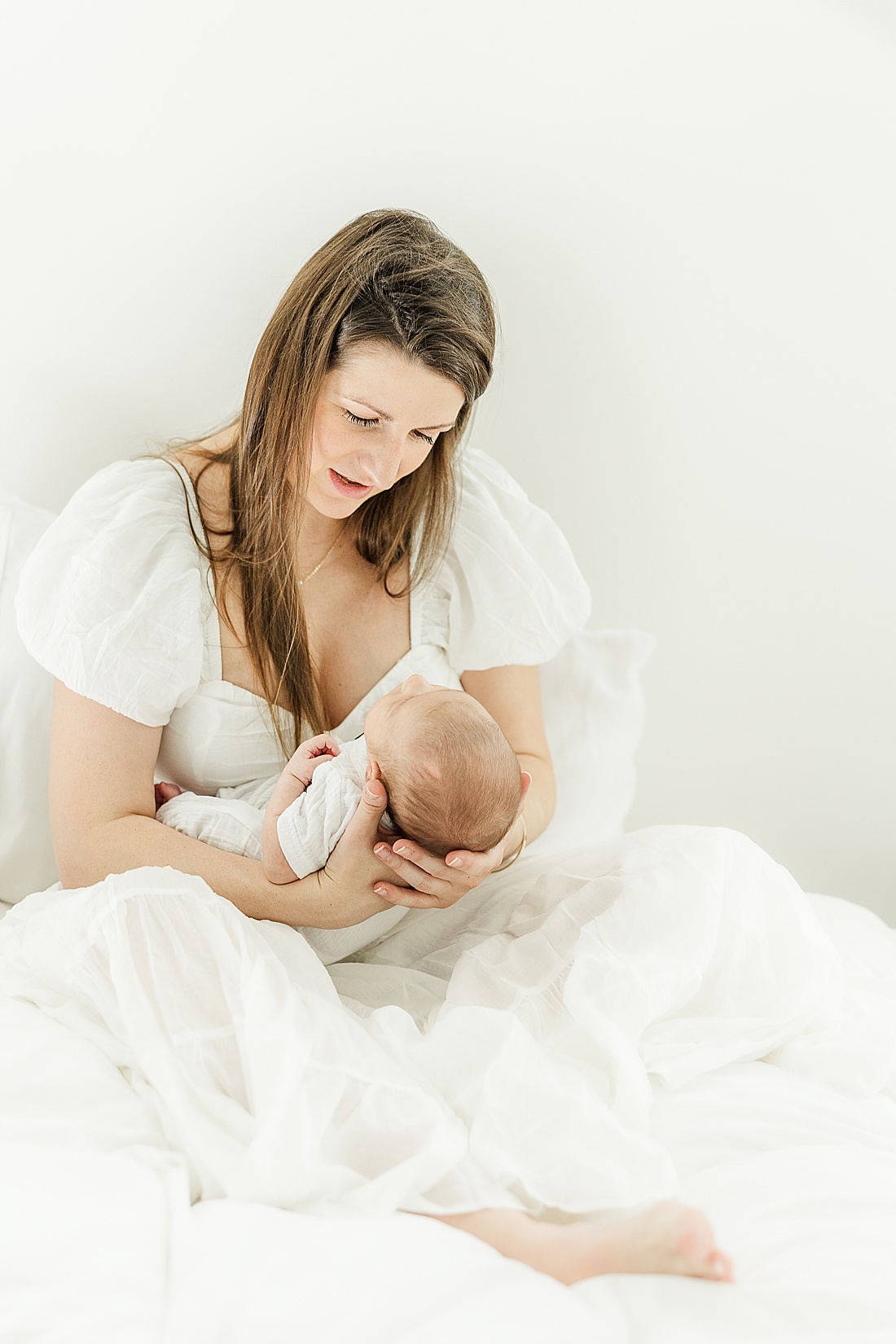 mom holds baby during in-home photo session in Millis Massachusetts with Sara Sniderman Photography