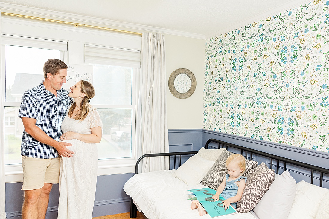 girl reads book during in home family photo session with Sara Sniderman Photography in Metro West Boston