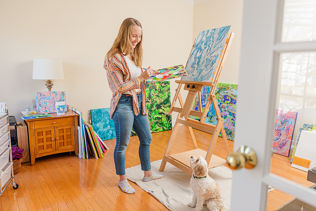 woman paints during in home family photo session with Sara Sniderman Photography in Metro West Boston