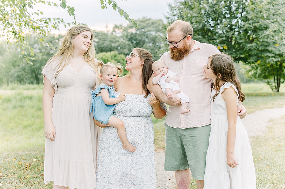 Image of professional family photo session taken by Sara Sniderman Photography, a family, newborn and maternity photographer serving the Metro West Boston area include: Natick, Needham, Newton, Wellesley, Wayland, Weston, Sherborn, Sudbury, Southborough, Medfield, Medway, Holliston, Framingham. The image is of a family smiling together