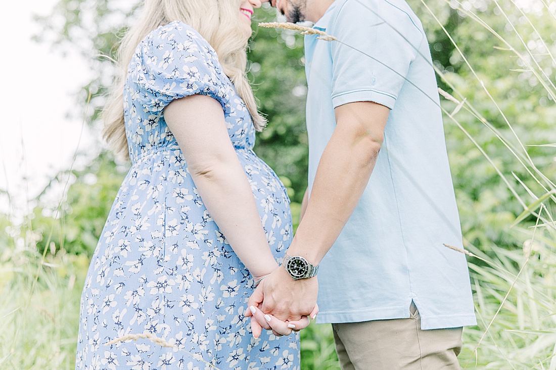 Image of professional maternity and newborn photo session taken by Sara Sniderman Photography, a family, newborn and maternity photographer serving the Metro West Boston area include: Natick, Needham, Newton, Wellesley, Wayland, Weston, Sherborn, Sudbury, Southborough, Medfield, Medway, Holliston, Framingham. The image is of couple holding hands during maternity session