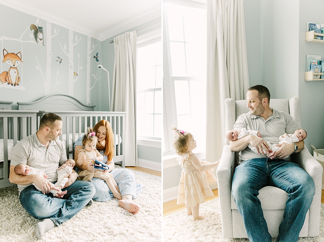 family sits in nursery reading book during twin newborn photo session in Natick Massachusetts with Sara Sniderman Photography