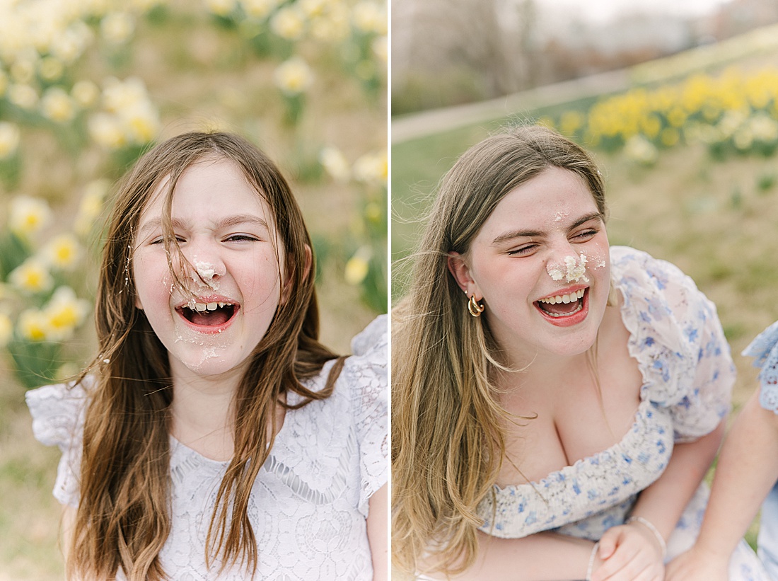 girls laugh with cake on face during first birthday photo session with Sara Sniderman Photography in Wellesley Massachusetts