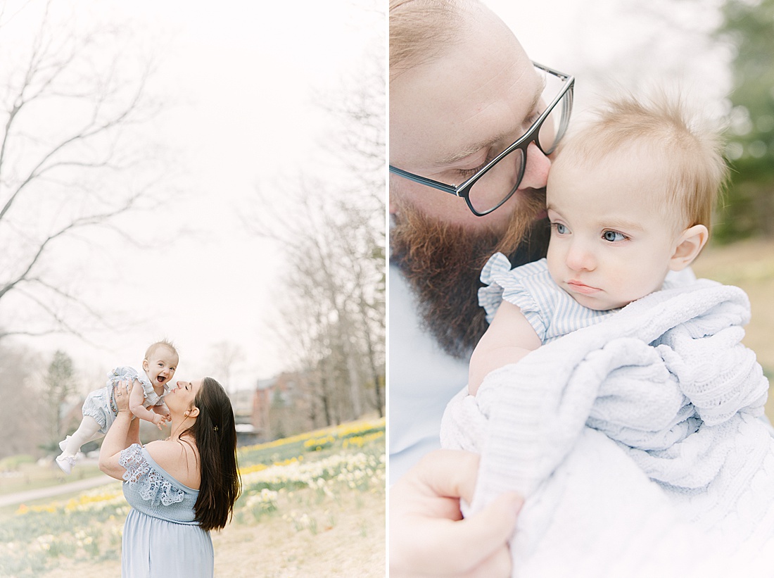parents hold birthday girl during first birthday photo session with Sara Sniderman Photography in Wellesley Massachusetts