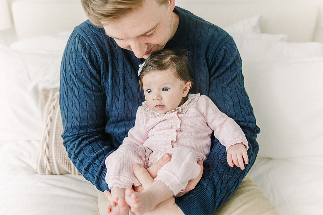 dad hold baby during in-home newborn photo session with Sara Sniderman Photography in Norwood Massachusetts